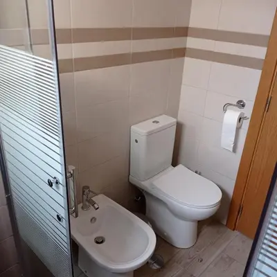 a bathroom with a toilet and a sink at Casa do Outeiro - T2 Quarteira velha in Quarteira