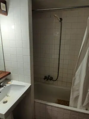 a bathroom with a tub and a sink and a shower at Studio Açoteias 410 in Albufeira