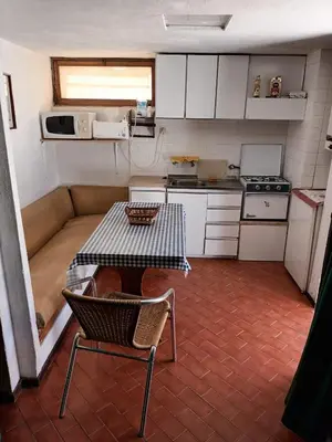 a small kitchen with a table and a couch at Studio Açoteias 410 in Albufeira