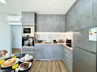 a kitchen with a table with plates of food on it at Albufeira Shine by Homing in Albufeira