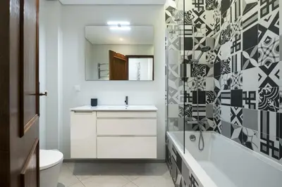 a bathroom with a sink and a toilet and a mirror at Vilamoura fresh by Hd in Vilamoura
