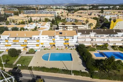 an aerial view of a building with a swimming pool at Vilamoura fresh by Hd in Vilamoura