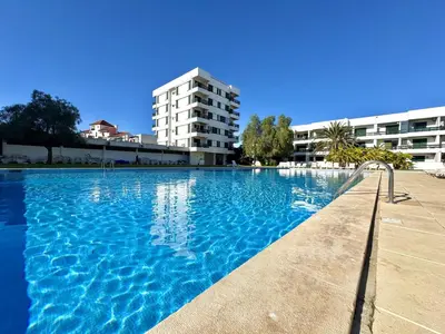 a large swimming pool in front of a building at Vilamoura Downtown by Homing in Vilamoura