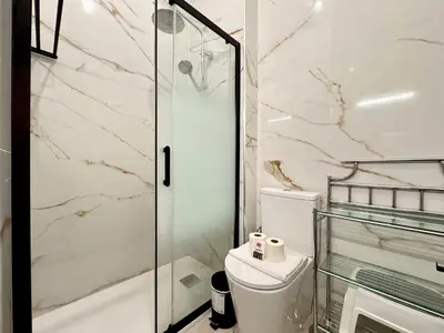 a bathroom with a toilet and a glass shower at Vilamoura Downtown by Homing in Vilamoura