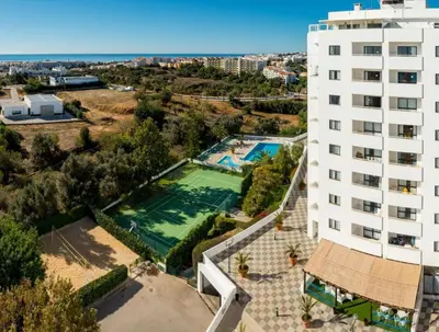 a bed with two white towels on top of it at Albufeira Olympics 1BR Apartment with Pool & Balcony, by Hopstays in Albufeira