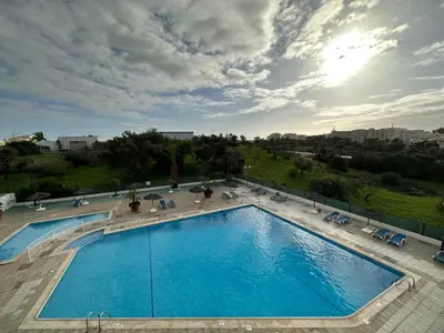 a gym with several treadmills and machines in it at Albufeira Olympics 1BR Apartment with Pool & Balcony, by Hopstays in Albufeira