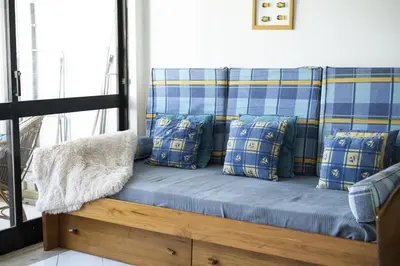 a blue couch with blue pillows in a room at Vilamoura central by HD in Vilamoura