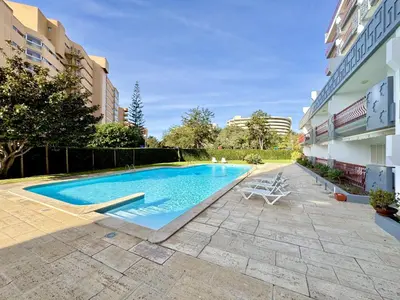 a swimming pool in the middle of a building at Vilamoura Marina Beach With Pool by Homing in Vilamoura