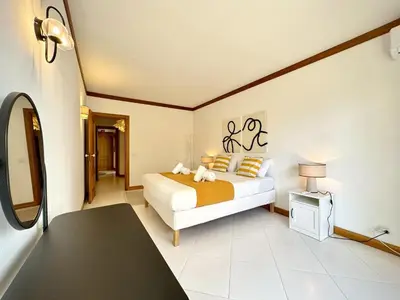 a bedroom with a bed and a table in a room at Vilamoura Marina Beach With Pool by Homing in Vilamoura