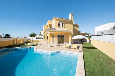 a villa with a swimming pool in front of a house at Villa Lando in Guia