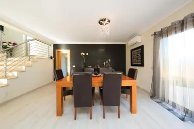a dining room with a wooden table and chairs at Villa Lando in Guia