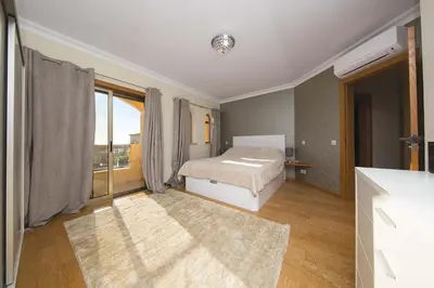 a bedroom with a bed and a large window at Villa Lando in Guia