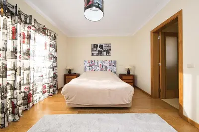 a bedroom with a bed and a wall of pictures at Villa Lando in Guia