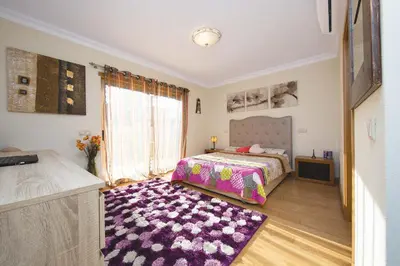 a bedroom with a bed and a purple rug at Villa Lando in Guia