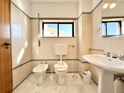 a bathroom with a toilet and a sink at Albufeira Vintage Apartment 2 With Pool by Homing in Albufeira