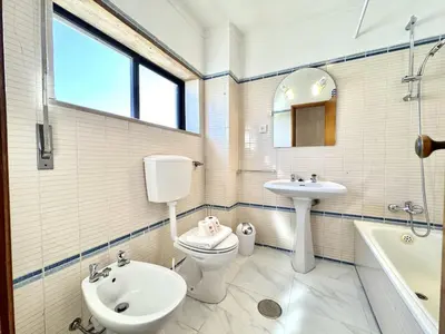 a bathroom with a toilet and a sink and a tub at Albufeira Vintage Apartment 2 With Pool by Homing in Albufeira