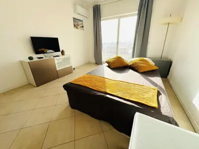 a bedroom with a large bed and a television at Blue Apartament in Albufeira