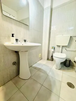 a bathroom with a sink and a toilet at Apartamento gourmet com quintal in Albufeira