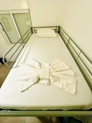 a bed with a shirt and a bow tie on it at Amazing Space - 4 Bedroom in Albufeira