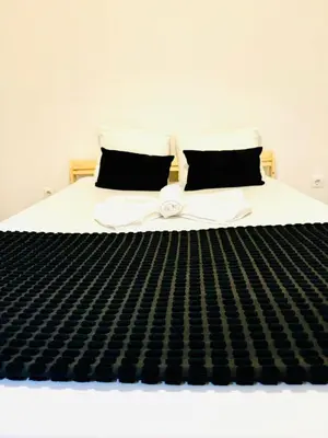 a bed with a black and white striped mattress at Amazing Space - 4 Bedroom in Albufeira