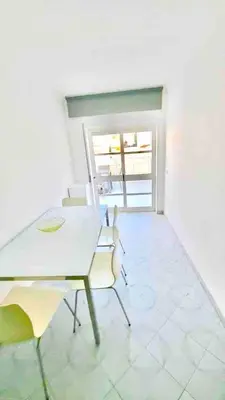 a dining room with a white table and chairs at Apartamento 5 estrelas praia da oura in Albufeira