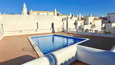 a swimming pool on the roof of a house at Apartamento 5 estrelas praia da oura in Albufeira