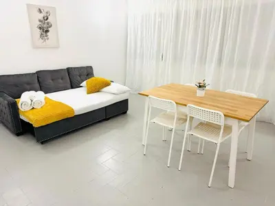 a bedroom with a bed and a table and chairs at Apartment in Vilamoura Park in Quarteira
