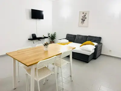a bedroom with a white bed with two tables at Apartment in Vilamoura Park in Quarteira