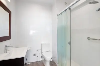 a bathroom with a toilet and a sink and a shower at Delmar in Quarteira