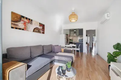 a living room with a couch and a table at Abertura Mar Zen in Quarteira