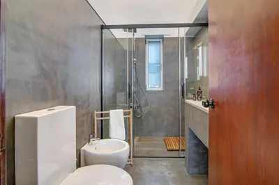 a bathroom with a shower and a toilet and a sink at Bento Box Villa Family Hub Fitness in Vilamoura
