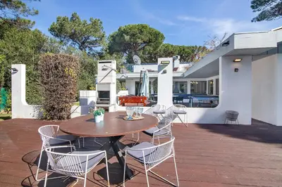 a patio with a table and chairs and a house at Bento Box Villa Family Hub Fitness in Vilamoura