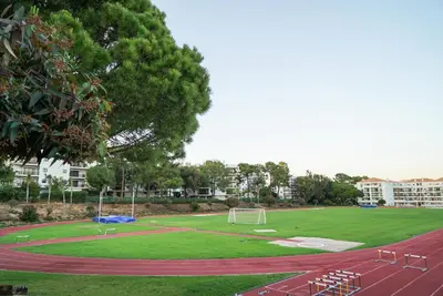 a soccer field with a soccer ball on a track at Pine Cliff Apartment by The Portuguese Butler in Olhos de Água