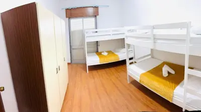 a room with two bunk beds and a hallway at Faro Family Apartment in Faro