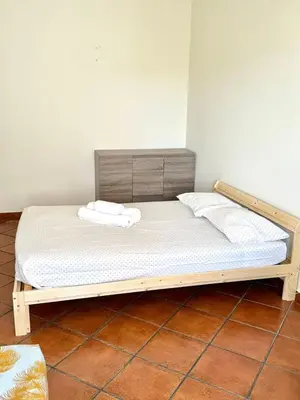 a bed with a wooden frame in a room at Fabulous Praia dos Pescadores in Albufeira