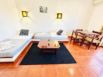 a living room with two beds and a table at Condominio privado T1 Rua da Oura in Albufeira