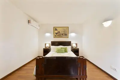 a bedroom with a bed and a painting on the wall at Villa Monte Domingos Simoes in Albufeira
