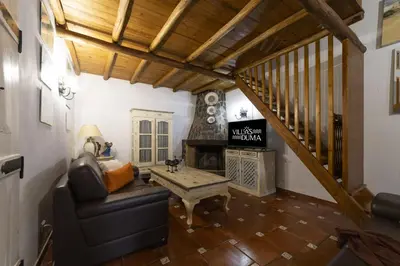 a living room with a couch and a fireplace at Villa Monte Domingos Simoes in Albufeira