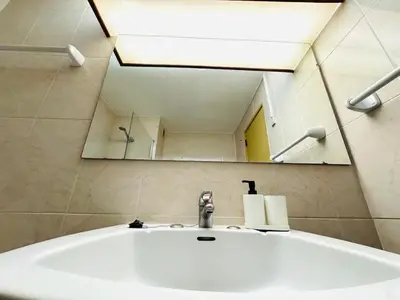 a bathroom sink with a large mirror above it at Condominio vila nova T1 Rua da Oura in Albufeira