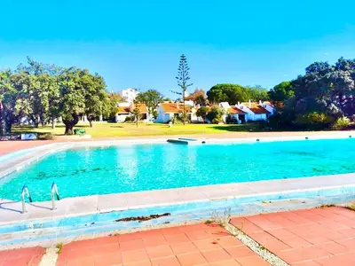 a large swimming pool with blue water at Resort Albufeira T1, Oura Beach in Albufeira