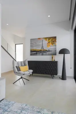 a living room with a chair and a picture on the wall at Villa Clipper in Guia