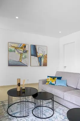 a living room with two tables in front of a couch at Villa Clipper in Guia