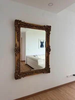 a mirror on a wall with a bed in a room at Sundown Pines Vilamoura in Quarteira