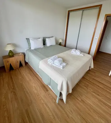 a bedroom with a bed with two towels on it at Sundown Pines Vilamoura in Quarteira