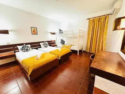 a bedroom with a large bed with yellow sheets at Resort Albufeira T1, Oura Beach in Albufeira