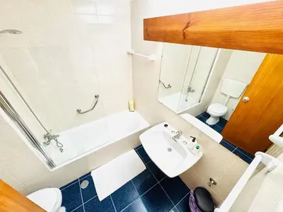a bathroom with a sink and a toilet and a shower at Studio Vila Nova in Albufeira