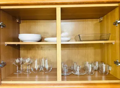a cabinet filled with glasses and bowls and plates at Studio Vila Nova in Albufeira