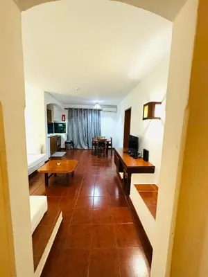 a large living room with a table and a couch at Studio Vila Nova in Albufeira