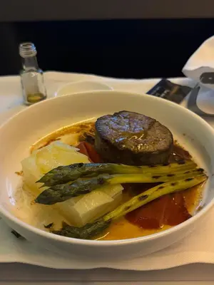 a bowl of food with meat and vegetables on a table at Red Apartament Praia da Oura in Albufeira