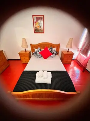 a bedroom with a bed with two towels on it at Red Apartament Praia da Oura in Albufeira